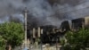 Local residents stand at a site of a Russian missile strike, amid Russia's attack on Ukraine, in Odessa, Ukraine, June 24, 2024. 