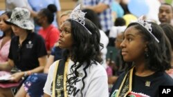 Miss Juneteenth Arizona Shaundrea Norman, 17, left, and Teen Miss Juneteenth Arizona Kendall McCollun, 15, attend an annual Juneteenth celebration at Eastlake Park in Phoenix, June 18, 2022. 