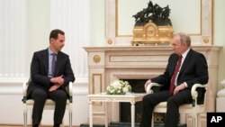 Russian President Vladimir Putin, right, listens to Syrian President Bashar al-Assad during their meeting at the Kremlin in Moscow, Russia, March 15, 2023.