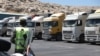 A convoy of trucks carrying humanitarian aid is seen parked after crossing the Syrian Bab al-Hawa border crossing with Turkey, on July 10, 2023. 