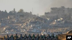 Israeli soldiers take positions near the Gaza Strip border, in southern Israel, Dec. 11, 2023. 