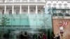 People walk outside The Hotel Palais Coburg, where talks are planned to resume on reviving the 2015 Iran nuclear deal - the Joint Comprehensive Plan of Action (JCPOA) - in Vienna, Dec. 27, 2021.