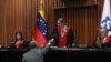 Handout picture released by the Venezuelan Electoral Council (CNE) shows the President of the CNE Elvis Amoroso shaking hands with Venezuelan Supreme Court of Justice (TSJ) President Caryslia Rodriguez in Caracas on August 5, 2024.