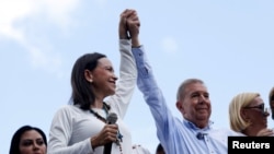 FILE PHOTO: Opposition leader Maria Corina Machado and opposition candidate Edmundo Gonzalez gesture as they address supporters