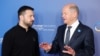 (FILES) German Chancellor Olaf Scholz (R) greets Ukrainian President Volodymyr Zelensky as he arrives to attend the Ukraine Recovery Conference in Berlin on June 11, 2024.