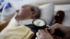 A nurse checks the pressure in the trachea of an 83 year-old man in a permanent vegetative state, at the Franziska Schervier intensive care nursing home in Frankfurt April 12, 2011. The patient has been in this condition since suffering a stroke. REUTER