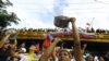 TOPSHOT - A man bangs a cooking pot during a protest against Venezuelan President Nicolas Maduro's government in Valencia, Carabobo state, Venezuela on July 29, 2024, a day after the Venezuelan presidential election.