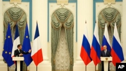 Russian President Vladimir Putin, right, listens during a joint press conference with French President Emmanuel Macron after their talks Monday, Feb. 7, 2022 in Moscow.