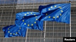 FILE PHOTO: European Union flags flutter outside the EU Commission headquarters in Brussels