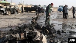 Iraqi security forces inspect the scene of a car bomb attack in Ramadi, 70 miles (115 kilometers) west of Baghdad, Iraq, 12 Dec 2010